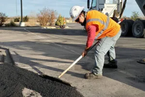 encore pavement employee spreading asphalt