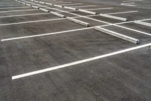white parking lot stripes with curb stops