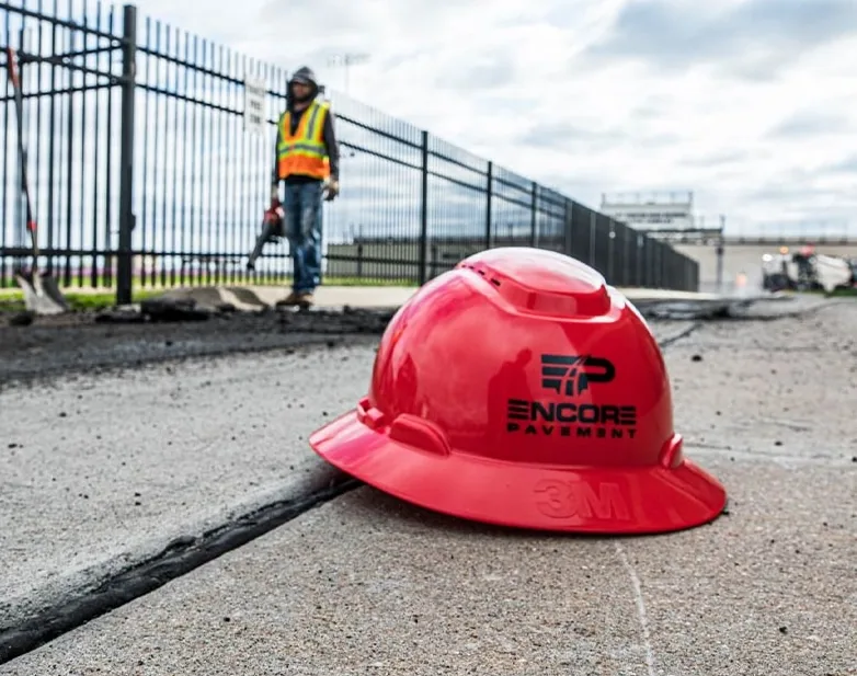 Encore Pavement hardhat on ground at job site.