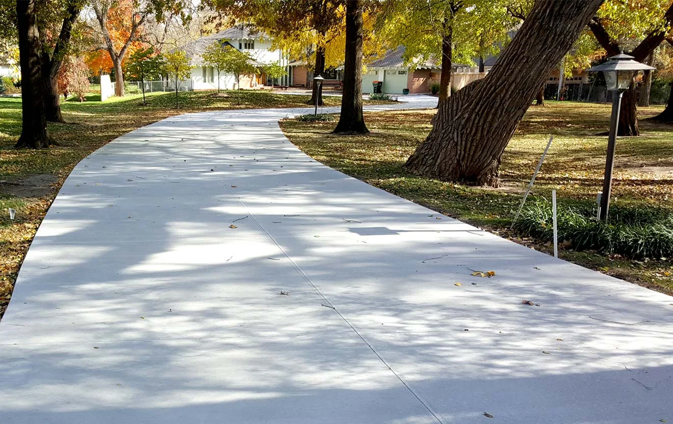 Freshly laid large residential concrete driveway.