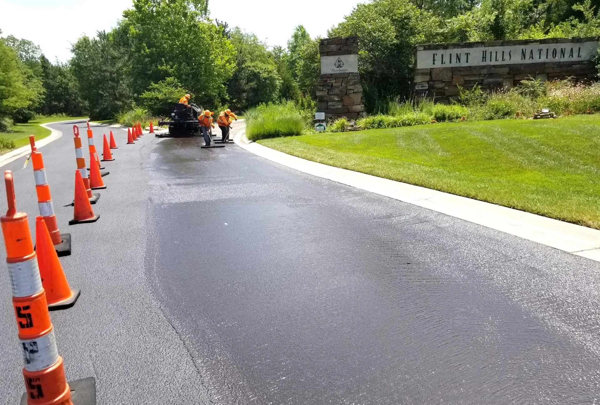 encore pavement employees working on a street