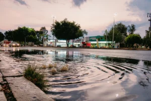 water pooling on a road at sunset