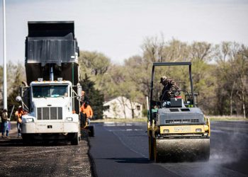 encore pavement employee on an asphalt roller