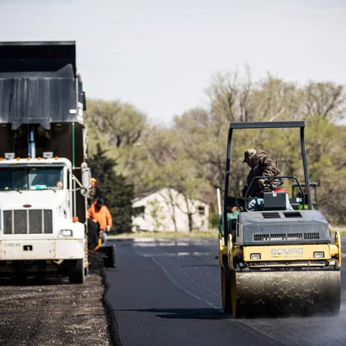 encore pavement employee on an asphalt roller