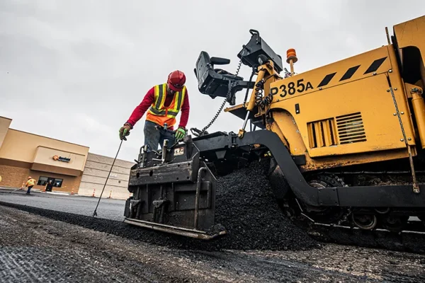 encore pavement employee on asphalt machine