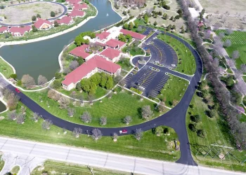 aerial view of spiritual life center, parking lot, and driveway