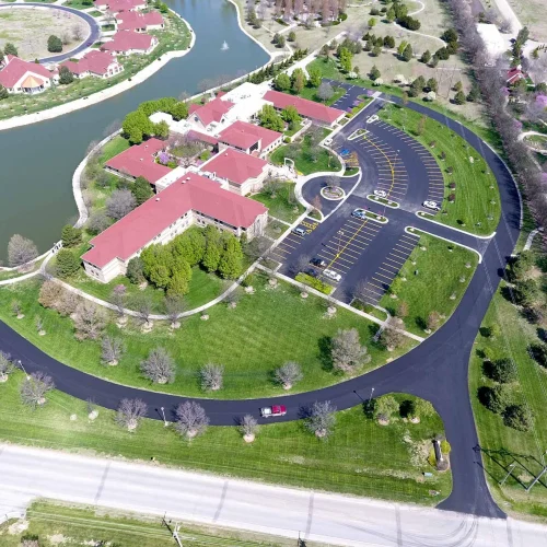 aerial view of spiritual life center, parking lot, and driveway