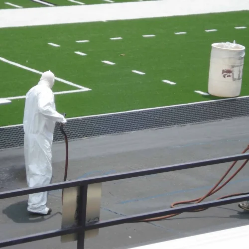 encore pavement employees painting the pavement at bill snyder stadium