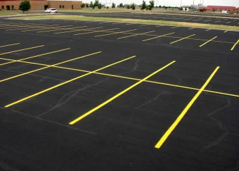 freshly painted yellow parking lot lines at maize high school in maize kansas