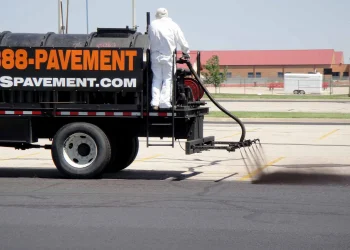 sealcoating truck in maize high school parking lot