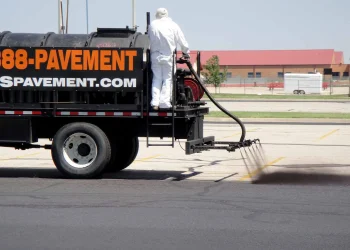 sealcoating truck in maize high school parking lot