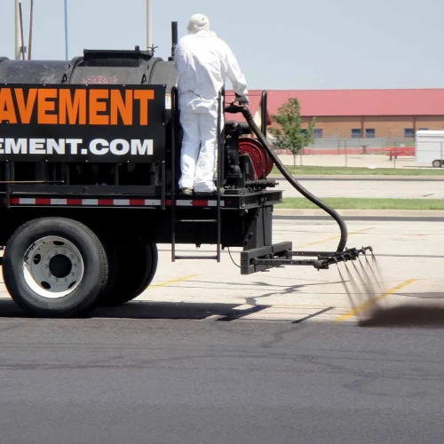 sealcoating truck in maize high school parking lot