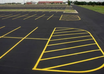 freshly painted yellow parking lot lines at maize high school in maize kansas