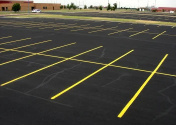 freshly painted yellow parking lot lines at maize high school in maize kansas
