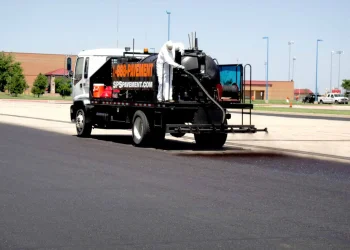 sealcoating truck in maize high school parking lot