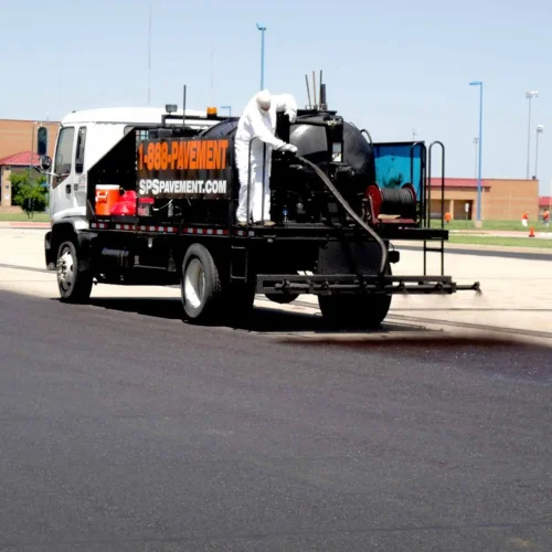 sealcoating truck in maize high school parking lot