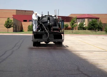 sealcoating truck in maize high school parking lot