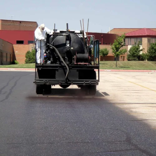 sealcoating truck in maize high school parking lot