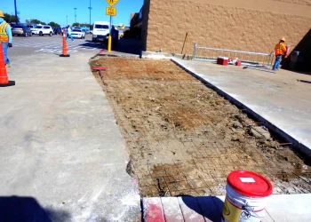 unfinished concrete walkway in front of walmart