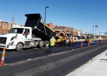 encore pavement employees outside of a dump truck
