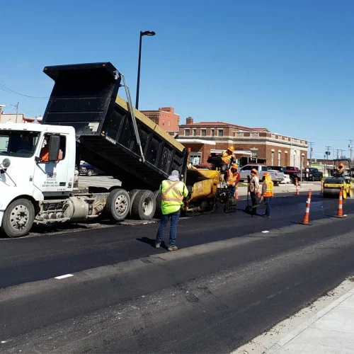 encore pavement employees outside of a dump truck