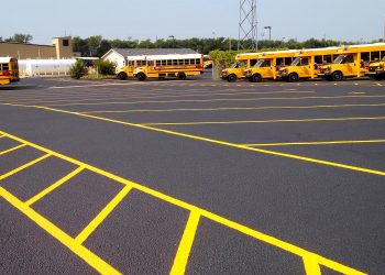 fresh sealcoat and pavement markings in a school bus parking lot
