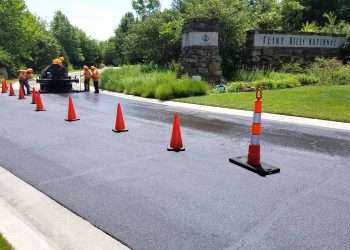encore pavement employees working on a street with traffic cones