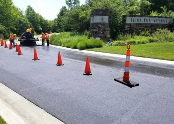 encore pavement employees working on a street with traffic cones
