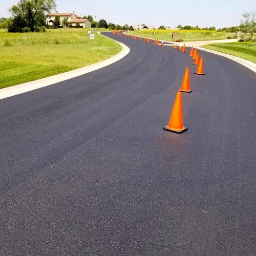 orange traffic cones in the middle of the road
