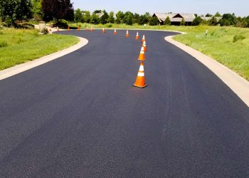 orange and white traffic cones in the middle of the road