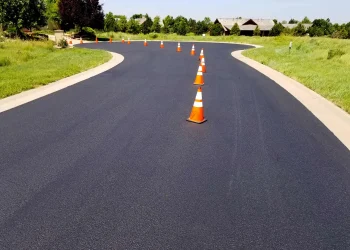 orange and white traffic cones in the middle of the road
