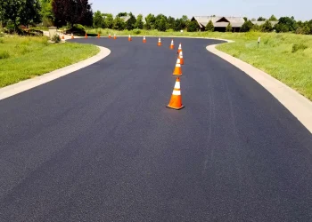 orange and white traffic cones in the middle of the road