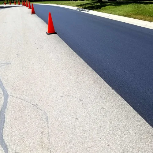 orange traffic cones in the middle of the road