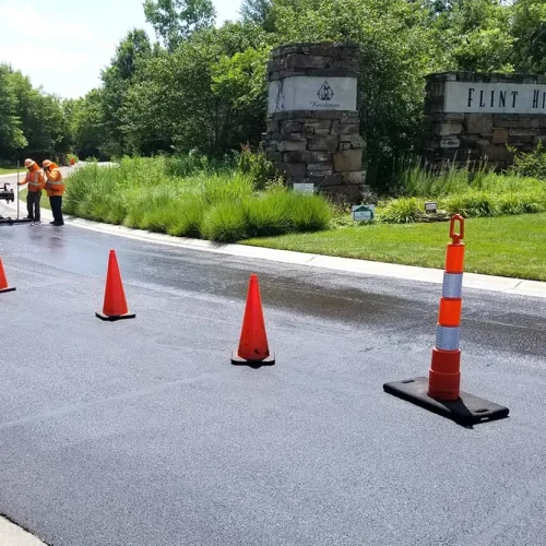 encore pavement employees working on a street