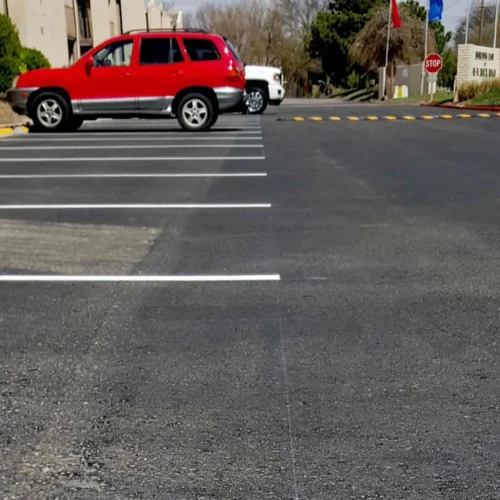 empty parking spaces and red suv at horizon east apartments